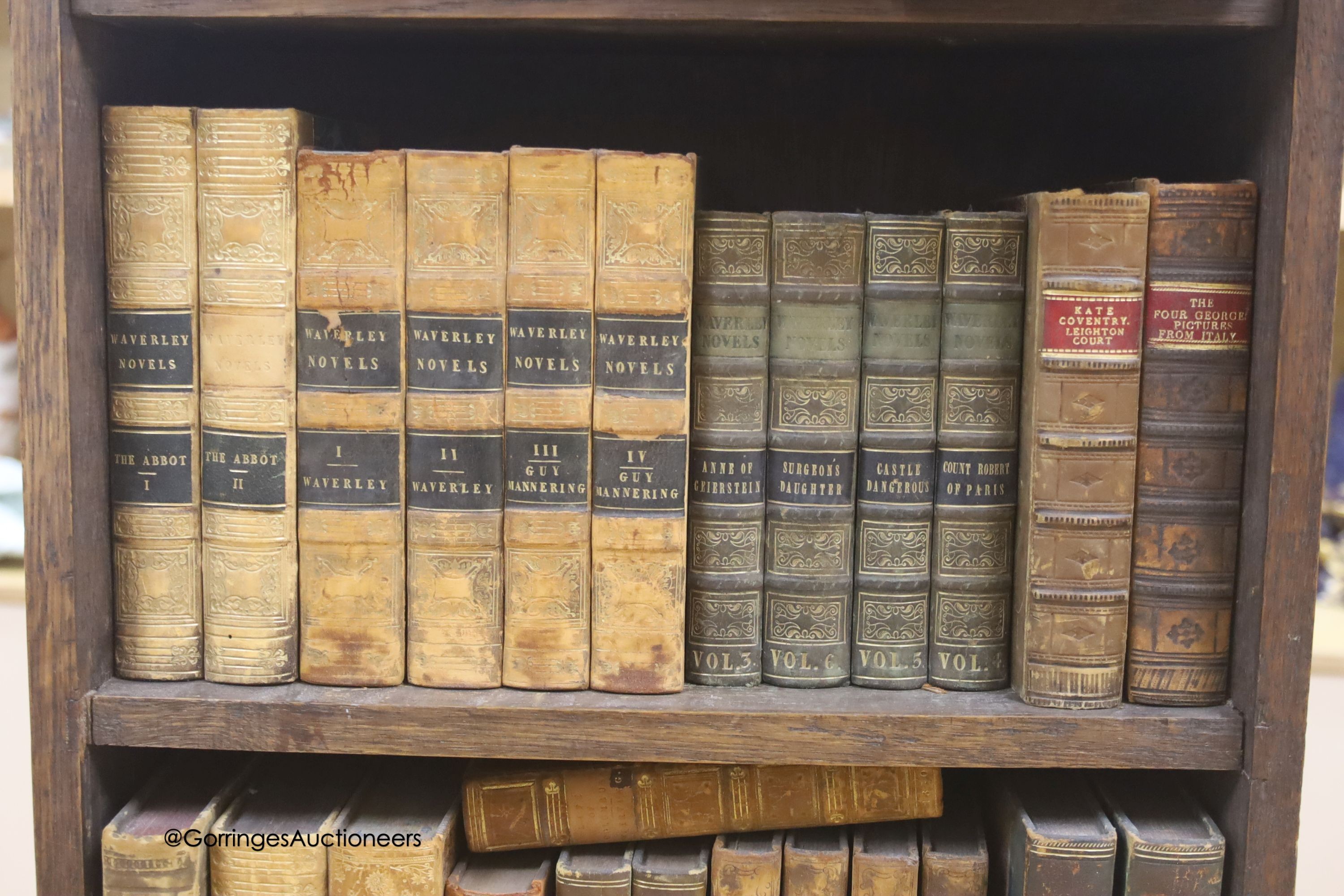 A group of 19th century leather bindings including Waverley Novels, Rob Roy, Tales of The Crusaders, etc., displayed in an oak bookcase, height 66cm